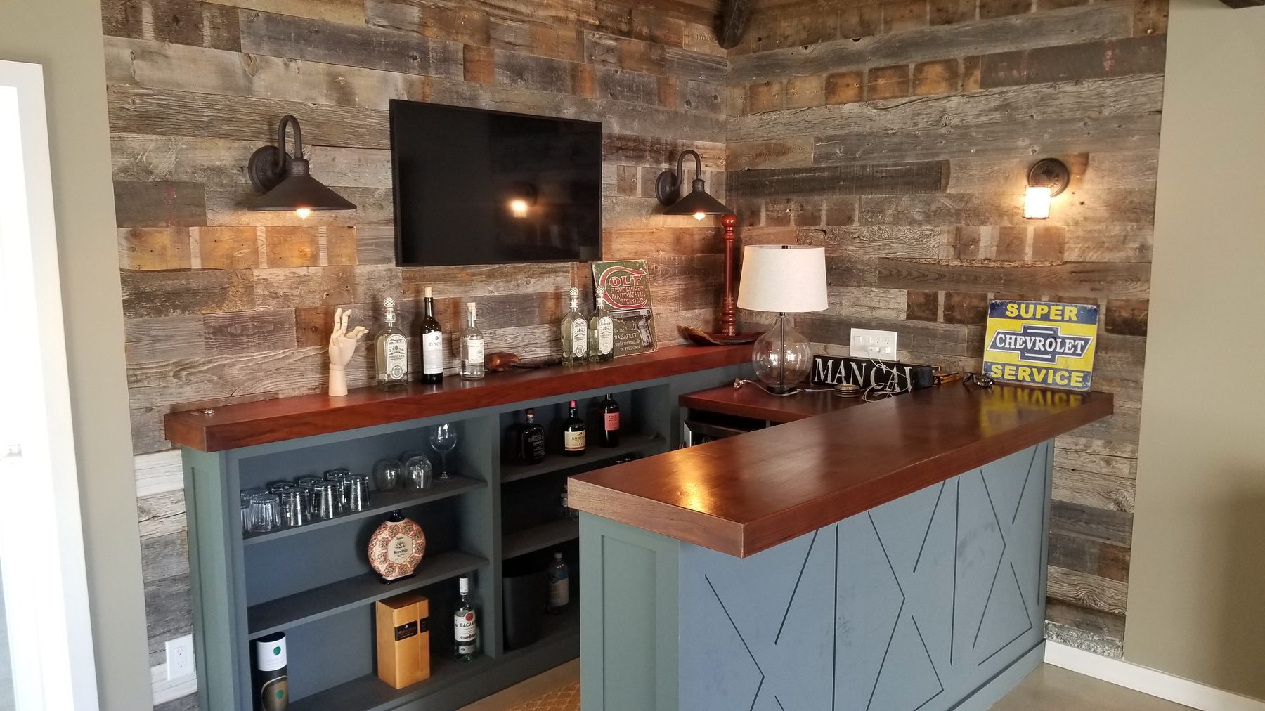Custom reclaimed-wood home bar with barn-wood feature wall