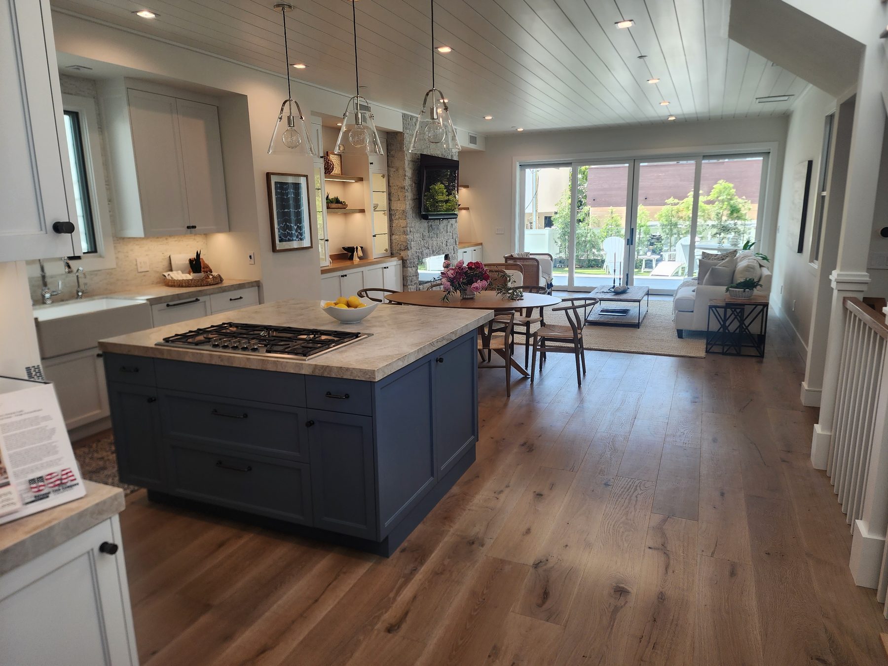Modern kitchen with blue island and marble countertop in Los Angeles