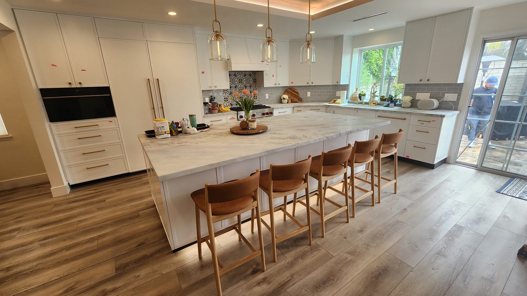 Bright white kitchen with large marble waterfall island